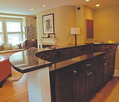 a large kitchen island in the middle of a living room