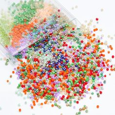 several different colored beads in a plastic container