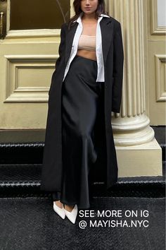 Looking for the perfect satin skirt outfit? Check IG @Mayisha.nyc to see different ways on how to style a silk black skirt. Long black skirt outfits are perfect for a night out on the town or a special event. Pair it with your favorite high heels and you're sure to turn heads. Follow us for more great NYC winter outfit ideas!