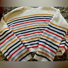 a striped sweater sitting on top of a counter