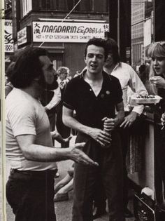 black and white photograph of men talking to each other