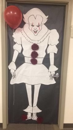 a door decorated with an image of a clown holding a red balloon