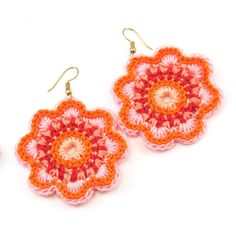 two crocheted flower shaped earrings on white background