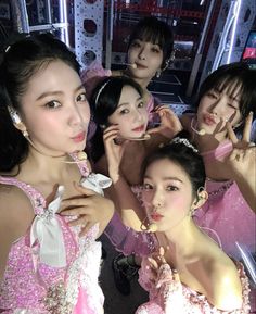 four girls in pink dresses posing for the camera