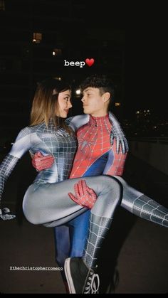 two people dressed up as spider man and woman, one holding the other's back