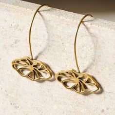 Elevate any look with these delicate floral drop earrings! Made from recycled bombshell brass - an amazing detail to share - these gorgeous golden-hued earrings are quick to slip on and add an elegant touch to any outfit. A Ten Thousand Villages Exclusive handcrafted by artisans with Rajana Association of Cambodia, which supports income generation and skills training, producing fair trade products using traditional Cambodian skills with contemporary design.