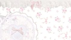 a pink wallpaper with flowers and bows on it's border is shown in this image