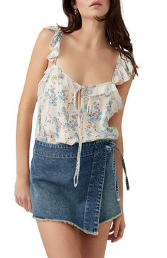 This flowery tank bodysuit is designed with soft ruffles and lovely lace. V-neck Adjustable straps 100% viscose with 95% polyamide, 5% elastane Machine wash, dry flat Imported Lace Ruffle Camisole Tank Top, Lace Ruffled Camisole Tank Top, Lace Ruffle Cami Tank Top, Lace Ruffled Cami Tank Top, Ruffled Lace Camisole, Feminine Camisole With Tie Straps For Spring, Summer Tank Top With Lace Trim And Ruffled Straps, Feminine V-neck Camisole With Ruffles, Feminine Summer Camisole With Ruffled Straps