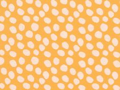 an orange and white polka dot pattern with small dots on it's back ground