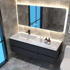 a bathroom with two sinks and a large mirror above the sink is illuminated by lights