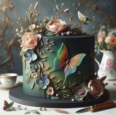 there is a cake decorated with flowers and butterflies on the table next to other decorations