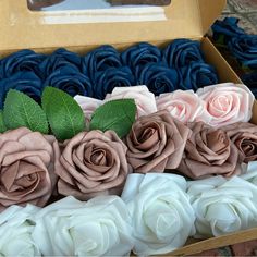 a box filled with lots of different colored roses