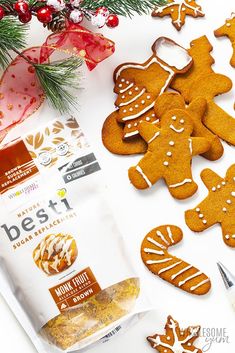 gingerbread cutouts are displayed on a white surface next to christmas decorations and supplies