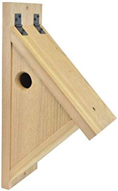 a wooden bird house with two holes in it