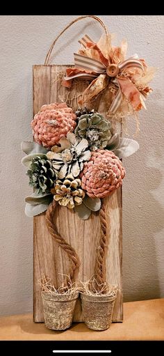 a wooden sign decorated with flowers and twine