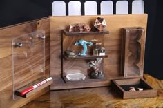 a wooden table topped with shelves filled with figurines