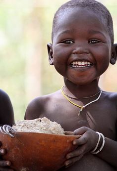 two young children are smiling and holding a bowl that says i am soul, soullogy