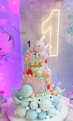 there is a cake that has been decorated with sea animals and bubbles on the table