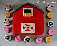 cupcakes are arranged in the shape of a barn and farm animals