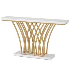 a white and gold console table with marble top