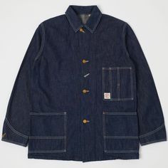 The 2875 coverall jacket from Full Count is a brilliant example of the simple things done well. Based on an early 20th-century workers chore coat, this jacket has become a tried and tested classic of the denim world. Its iconic boxy shape allows it to be easily worn over several layers and its beautiful lightweight denim means that it doesn’t stifle in the summer heat. Four vintage style gold buttons make up the front fastening and two large lower patch pockets have been added for convenience, w Workers Jacket, Ladbroke Grove, Boxy Jacket, Demin Jacket, Clothes Brand, Worker Jacket, Indigo Colour, Elevated Basics, Chore Coat