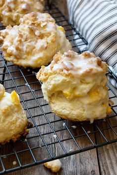 there are some muffins that are cooling on the rack and one is covered in icing