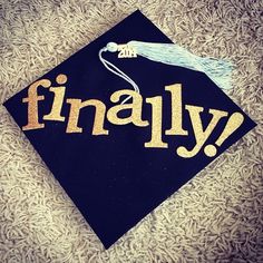 a graduation cap with the word finally written in gold letters on top of black fabric