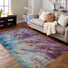 a living room with a couch and rug on the floor