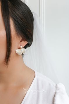 These Poppy Earrings are inspired by the elegant curves of flower petals and feature a lustrous pearl with eight shimmering hanging petals. They are perfect for the modern bride or bridesmaid, adding a romantic floral touch to any look. Earring Size: Length: 28 mm, Width: 27 mm (Approx.) MATERIALS: Gold Plated, Brass Faux Pearls Hypoallergenic (lead-free & nickel-free) Bridesmaids Earrings , Wedding Earrings, Pretty Earrings, Bridal Earrings, Bridal Jewelry, Bridesmaids Gifts, Flower Earrings, P White Flower Clip-on Earrings For Formal Events, Wedding Clip-on Flower Earrings, Elegant Petal Shaped 3d Flower Earrings, Petal-shaped Earrings For Wedding, Flower Shaped Clip-on Earrings For Wedding, Flower-shaped Earrings For Wedding, Flower Shaped Earrings For Wedding, White Petal Earrings For Wedding, White Petal-shaped Earrings For Wedding