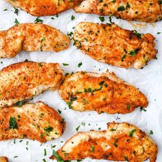 several pieces of chicken with parsley on top