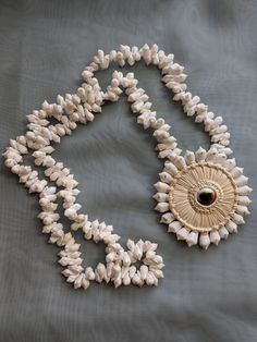 Vintage beach jewelry shell Operculum costume jewelry necklace for the summer.  Good vintage condition. Beach Pendant Jewelry Made Of Shell, Beach Shell Necklace Made Of Mother Of Pearl, Shell Pendant Jewelry For Vacation, Shell Pendant Necklace For Vacation, Shell-shaped Mother Of Pearl Necklace For Beach, Summer Shell Strand Necklaces, Beach Shell Necklace In Mother Of Pearl, Beach Shell Necklaces In Mother Of Pearl, Summer Shell Strand Necklace