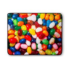 a pile of jelly beans sitting on top of a white surface