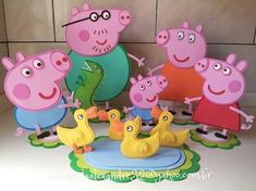 a group of peppa pig figurines standing next to each other on top of a table