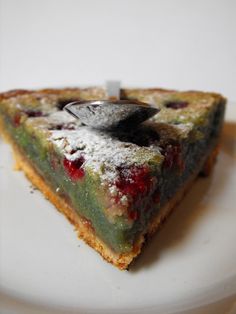 a piece of cake with powdered sugar on top is sitting on a white plate