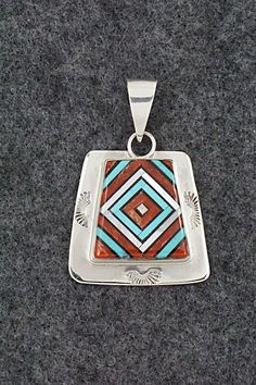 This beautiful turquoise, onyx, mother of pearl, coral and sterling silver inlay pendant and ring ring set was made by Zuni silversmith Vernon Vacit. The set is signed V. Vacit.Pendant Length: 1 1/2"Pendant Width: 1"Ring:Size: 9.5Length: 1 1/8"Width: 1/2"Free shipping on all orders! We ship with USPS and always include tracking. All orders ship within a day of payment.Returns are accepted up to 30 days after you receive your order. Just send us a message. Our shop offers cash back or store credi Artisan Red Jewelry With Inlay, Artisan Red Inlay Jewelry, Southwestern Inlay Jewelry For Anniversary, Southwestern Style Inlay Jewelry For Anniversary, Red Sterling Silver Jewelry With Inlay, Unique Rectangular Inlay Jewelry, Collectible Sterling Silver Square Pendant Jewelry, Collectible Sterling Silver Jewelry With Square Pendant, Southwestern Silver Jewelry With Inlay