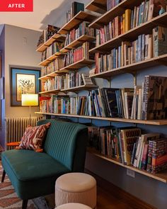 a green chair sitting in front of a book shelf filled with books