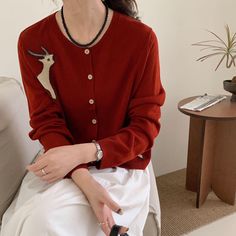 Stay cozy and stylish with our Handmade Wool Cardigan, featuring intricate deer embroidery. Available in rich red, classic camel, and elegant beige, this cardigan offers both comfort and timeless charm. Measurement - One Sized, Length 25.2inch, Sleeve 23.6inch, Chest 21.8inch  - The model is 5.5 ft Care instructions Dry flat, Use mild detergent, Hand wash cool, Do not use chlorine-based bleach, Cool iron (max 230 degrees), Dry clean Luxury Red Elegant Cardigan, Luxury Red Wool Cardigan, Luxury Red Classic Cardigan, Deer Embroidery, Cardigan For Women, Stay Cozy, Wool Cardigan, Cardigans For Women, Camel