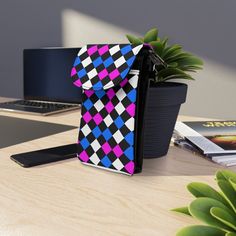 Crossbody Cell Phone Wallet Purse, Black Pink Blue Checkered Illustration. This crossbody shoulder bag is compact and adds a splash of style. It comes in one size (7.5" x 4.9") and features an extendable faux leather strap (29.6" to 51.2"). Two main compartments have a flip-up cover—one for a phone and three hidden ones for regular size cards. Made from high-grade microfiber leather. ● High-grade faux leather ● One size: 7.5" × 4.9" × 1" (19cm × 12.5cm × 2.5cm) ● Detachable, adjustable faux leat Trendy Black Shoulder Bag With Card Slots, Black Shoulder Bag With Card Slots, Blue Crossbody Wallet With Mobile Phone Bag, Checkered Illustration, Pink Crossbody Wallet With Phone Bag, Blue Crossbody Phone Bag With Card Slots, Pink Phone Bag With Adjustable Strap, Multicolor Crossbody Bag With Card Slots, Pink Crossbody Phone Bag For On-the-go