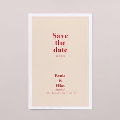 save the date card with red lettering on it