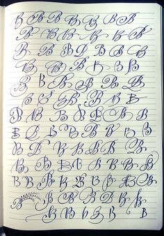 an open notebook with cursive writing on the pages and numbers in blue ink