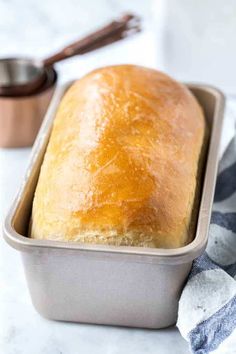 a loaf of bread sitting in a pan on top of a counter