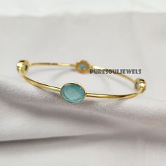 Aqua Chalcedony Bangle, 925 Silver Gold Plated Bangle, Gemstone Bangle, Friendship Bangle, Vintage Bangle, Bangle Bracelet, Designer Bangle Handmade item Gemstone: Aqua Chalcedony Materials: 925 Sterling Silver Finish: Gold Theme- Love & Friendship Style- Boho & Hippie Bangle Size-2.8X2.7 Inches Approx. Ready To Ship You can also have a look on our other amazing similar products here- >Blue Topaz Bangle- https://www.etsy.com/in-en/listing/1248466752/natural-blue-topaz-bangle-925-silver?click_key=4bc8f46c621d72ab25ab2e2efeeca74fecb3f791%3A1248466752&click_sum=1a79a935&ref=shop_home_active_20&pro=1&frs=1 >White Moonstone Bangle- https://www.etsy.com/in-en/listing/1262386807/white-moonstone-bangle-women-bangle-925?click_key=4d9f7b1ac7ee38f5c2b7fde576cac044956dc92b%3A1262386807&click_sum=eaa1a Fine Jewelry Bracelets With Stones, Adjustable Fine Jewelry Bracelets With Stones, Sterling Silver Bangle Bracelet With Natural Stones, Adjustable Sterling Silver Gemstone Bangle, Fine Jewelry Stone Bracelets, Fine Jewelry Bracelets With Stones As Gift, Fine Jewelry Bracelets With Stones For Gift, Adjustable Round Cuff Bracelet Fine Jewelry, Round Crystal Bracelet With Stones