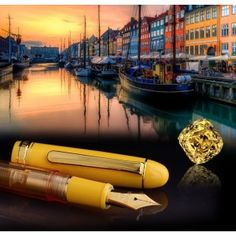 the fountain pen has been designed to look like it is floating on water with boats and buildings in the background