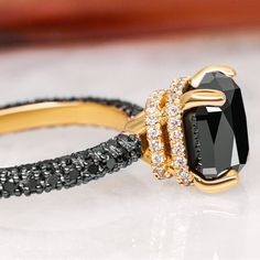 a black and gold ring with diamonds on it