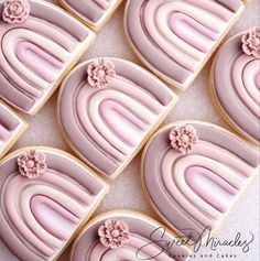 decorated cookies with pink frosting and flowers on them are arranged in a square pattern