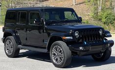 a black jeep is parked on the street