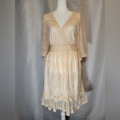 This New With Tags Dress Is In Overall Good Condition. Unworn. The Only Flaw To Note Is One Miniscule Dark Spot On The Bust. See Last Picture. Very Feminine Vintage Aesthetic. Beautiful Soft Peach Color. Lined With A Floral Lace Overlay. Fit And Flare, Flowy, With A Ruffle Hem.Hem. It Has A Crochet Detail Deep V-Neck And 1/2 Lace Bell Sleeves. It Has A Hidden Side Zipper Closure. Please See Pictures For Measurements To Ensure A Good Fit. It Is A Us Size 8, Neck Tag Has Uk Size 12 On It. Flowy V-neck Lace Dress For Spring, Beige V-neck Feminine Lace Dress, Beige V-neck Lace Dress For Spring, Feminine Apricot V-neck Dresses, Peach Lace Trim Dress For Spring, Peach Lace Trim Dress For Summer, Bohemian Apricot V-neck Dress, Apricot Bohemian V-neck Dress, Apricot Lace Trim Dress For Spring