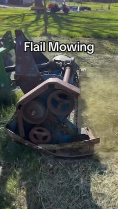 an old tractor sitting in the grass next to a building with words that read, fail mowing