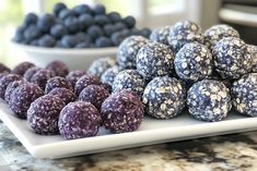 there are many different types of berries on the plate and one is blueberry cheesecake bites