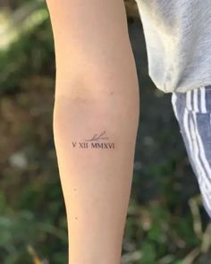 a person with a tattoo on their arm that says vixi mammave in cursive writing